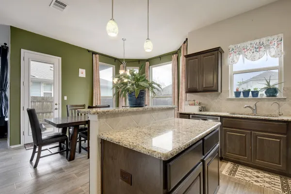 a kitchen with center island table and chairs in it
