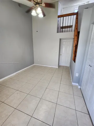 a room with walk in closet and wooden floor