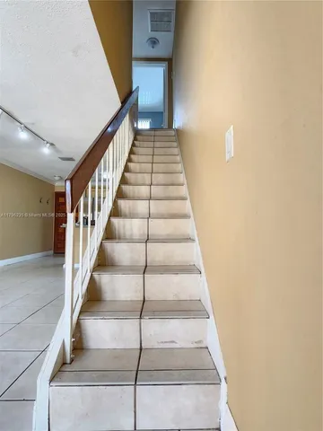 a white toilet sitting next to a shower