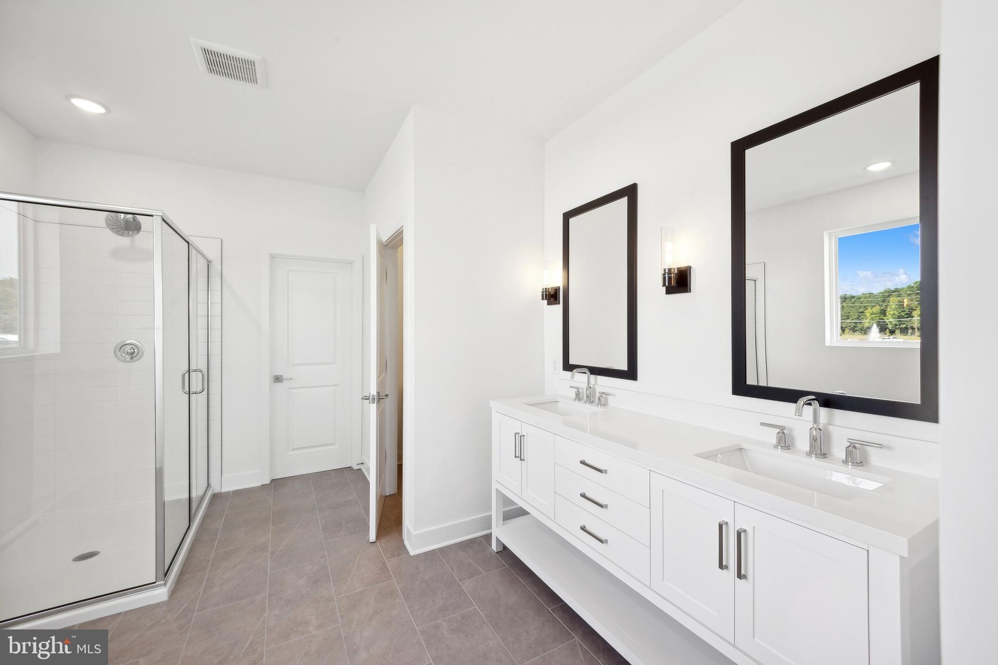 36453 Maple Ridge Lane Georgetown, DE 19947 - Photo 14 of 29 a bathroom with a double vanity sink and mirror