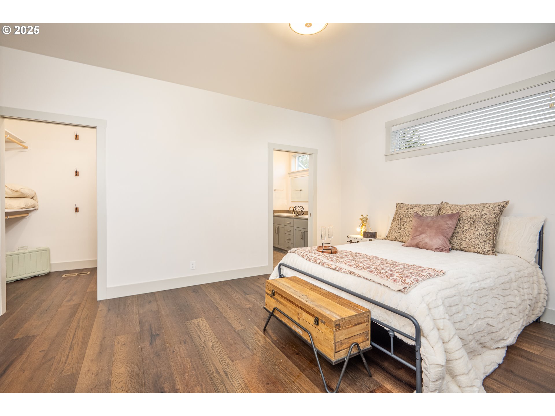 3352 Zane Lane Eugene, OR 97404 - Photo 16 of 42 a bedroom with a bed a table and wooden floor