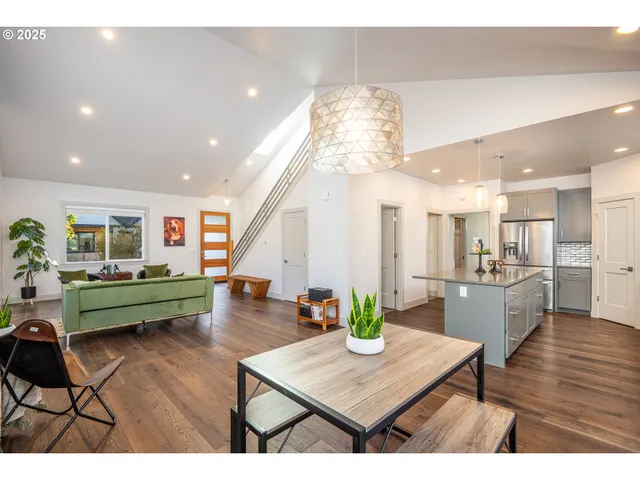 a dining room with furniture and a wooden floor