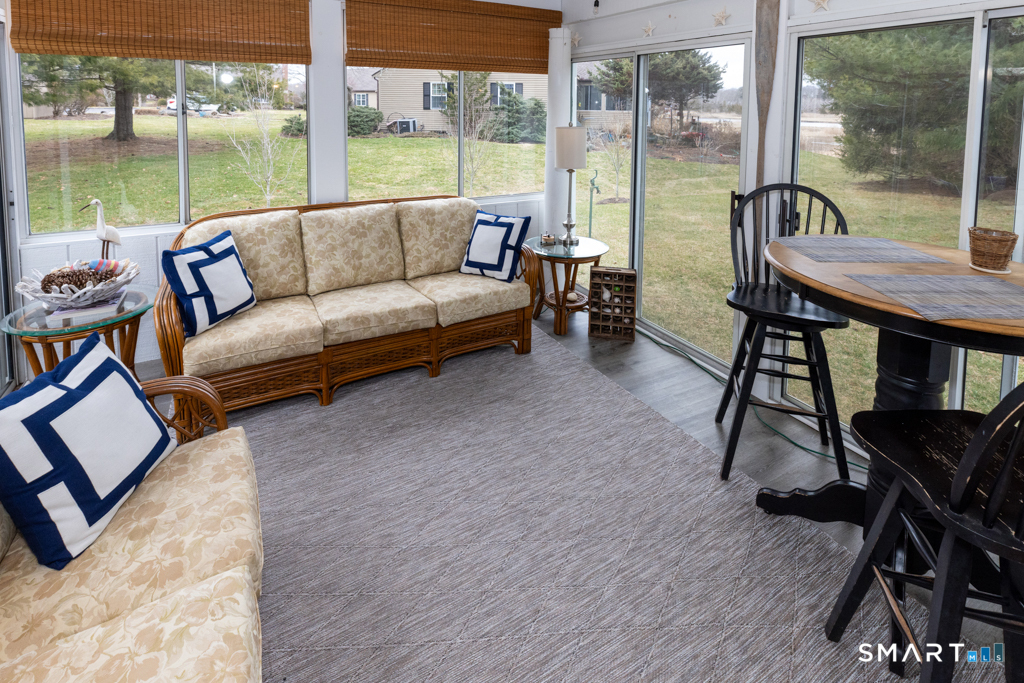 10 Runnymede Lane, Unit 10 Madison, CT 06443 - Photo 14 of 33 Open and airy sunroom with gorgeous views of the river