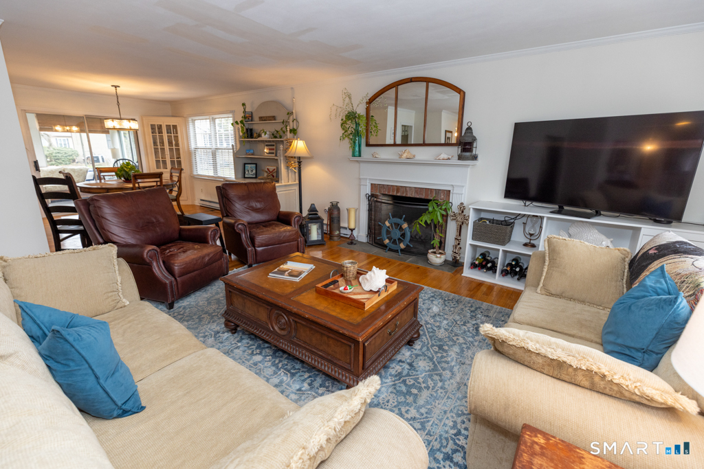 10 Runnymede Lane, Unit 10 Madison, CT 06443 - Photo 5 of 28 Warm and inviting living room w/fireplace