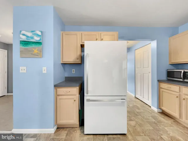 a white refrigerator freezer sitting in a kitchen