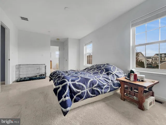 a bed sitting in a room next to a window