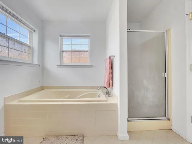 a bath tub sitting next to a window