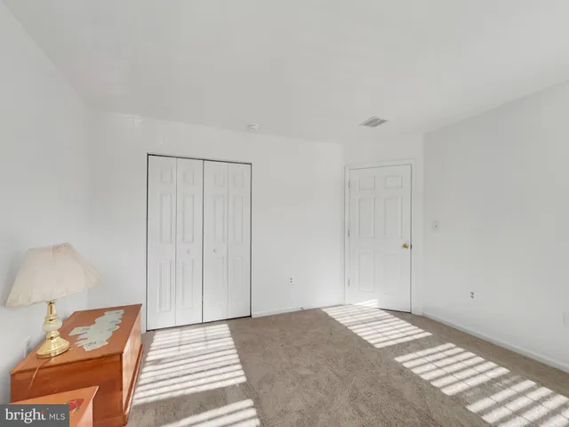 a bedroom with a bed and a lamp