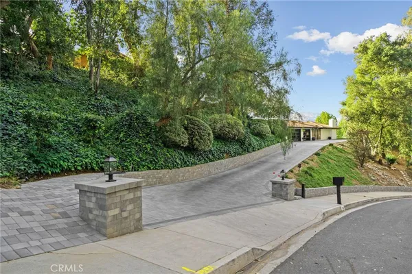 a kitchen with stainless steel appliances granite countertop a stove top oven a sink dishwasher a dining table and chairs with wooden floor