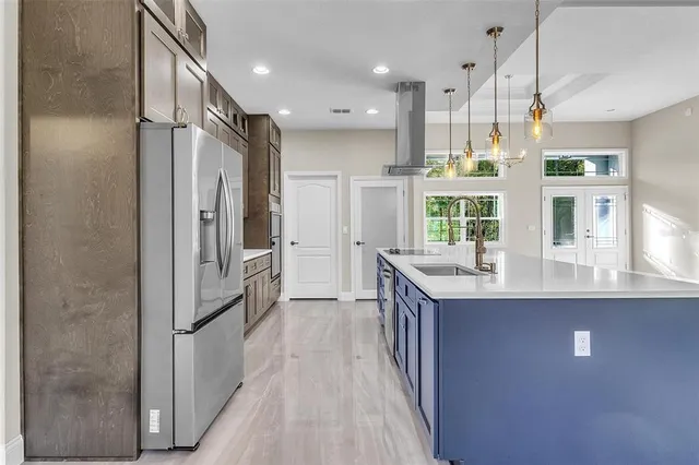 a kitchen with stainless steel appliances granite countertop a refrigerator and a sink