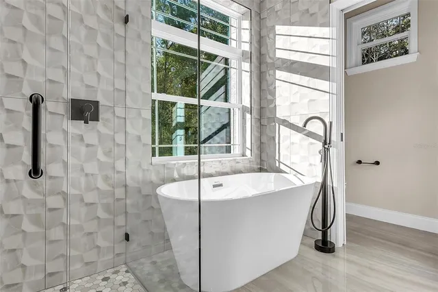 a bath tub sitting next to a window