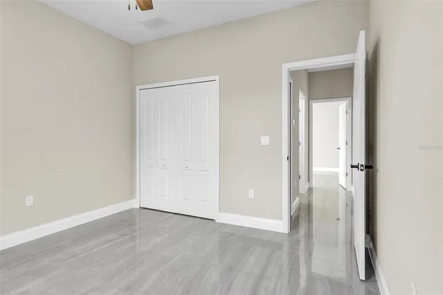 an empty room with wooden floor and closet