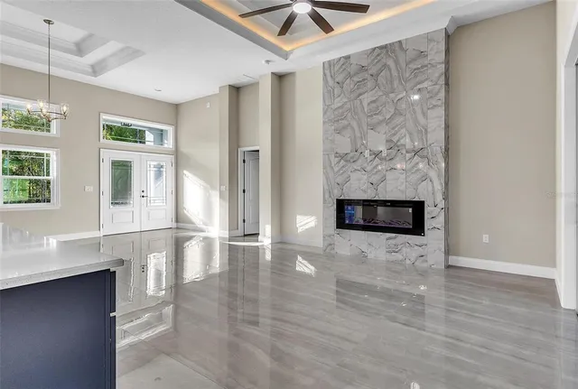 a view of a livingroom with wooden floor and a ceiling fan