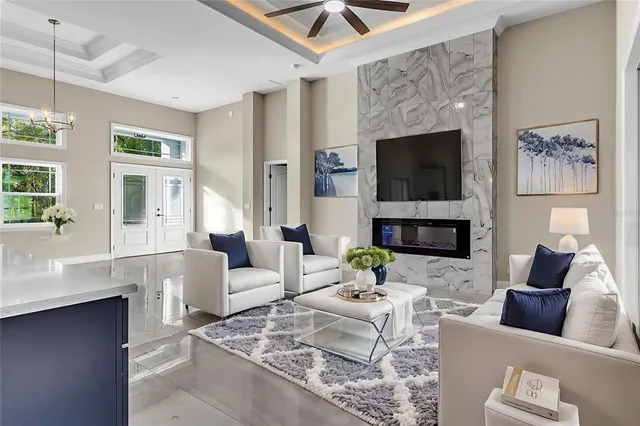 a living room with furniture a flat screen tv and a fireplace