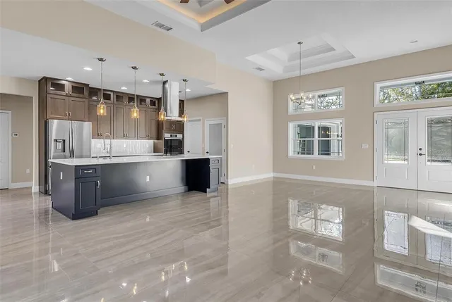 a large white kitchen with a large window