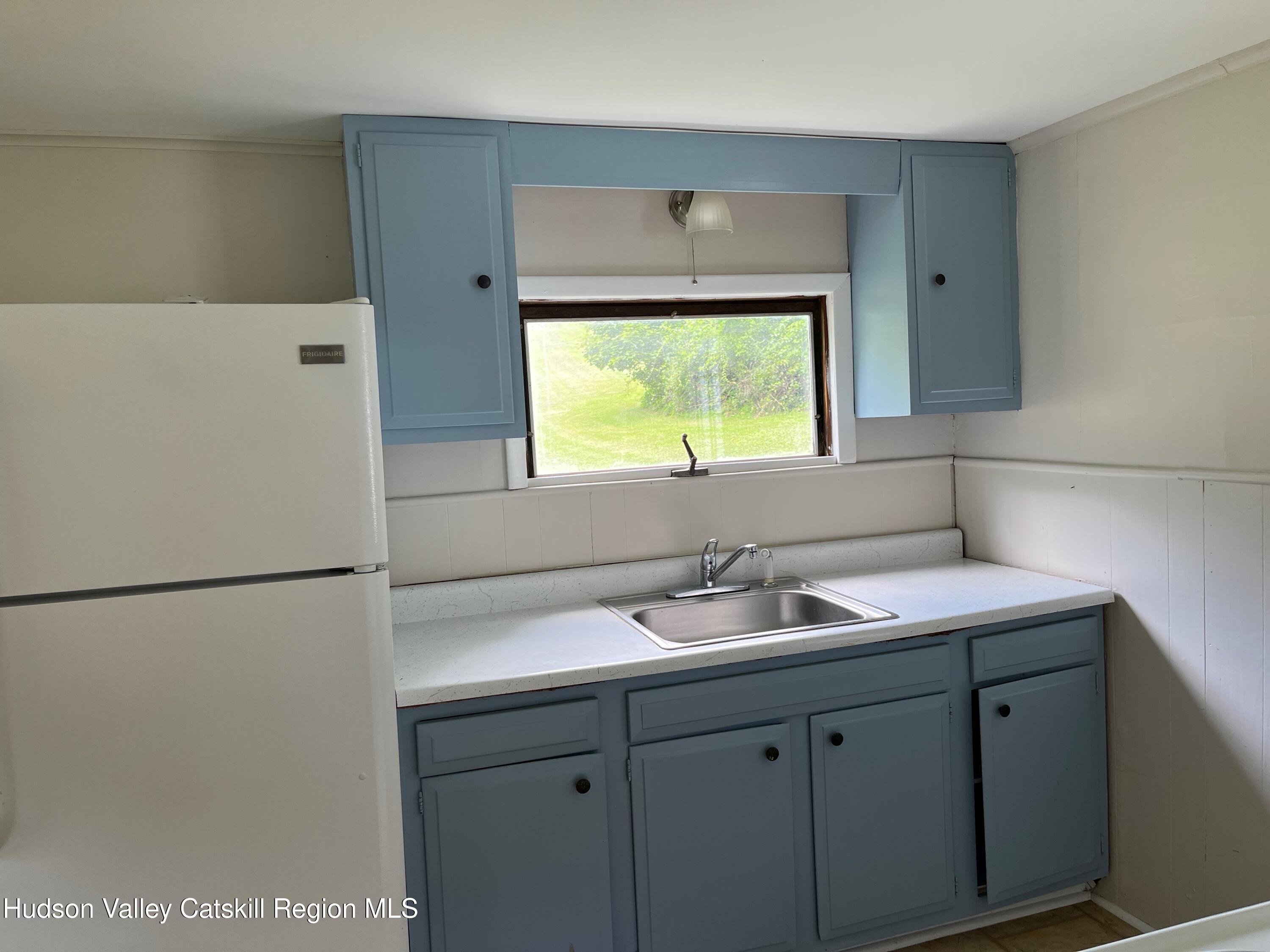 601 Fischer Road Kinderhook, NY 12106 - Photo 3 of 13 a kitchen with a sink and a refrigerator