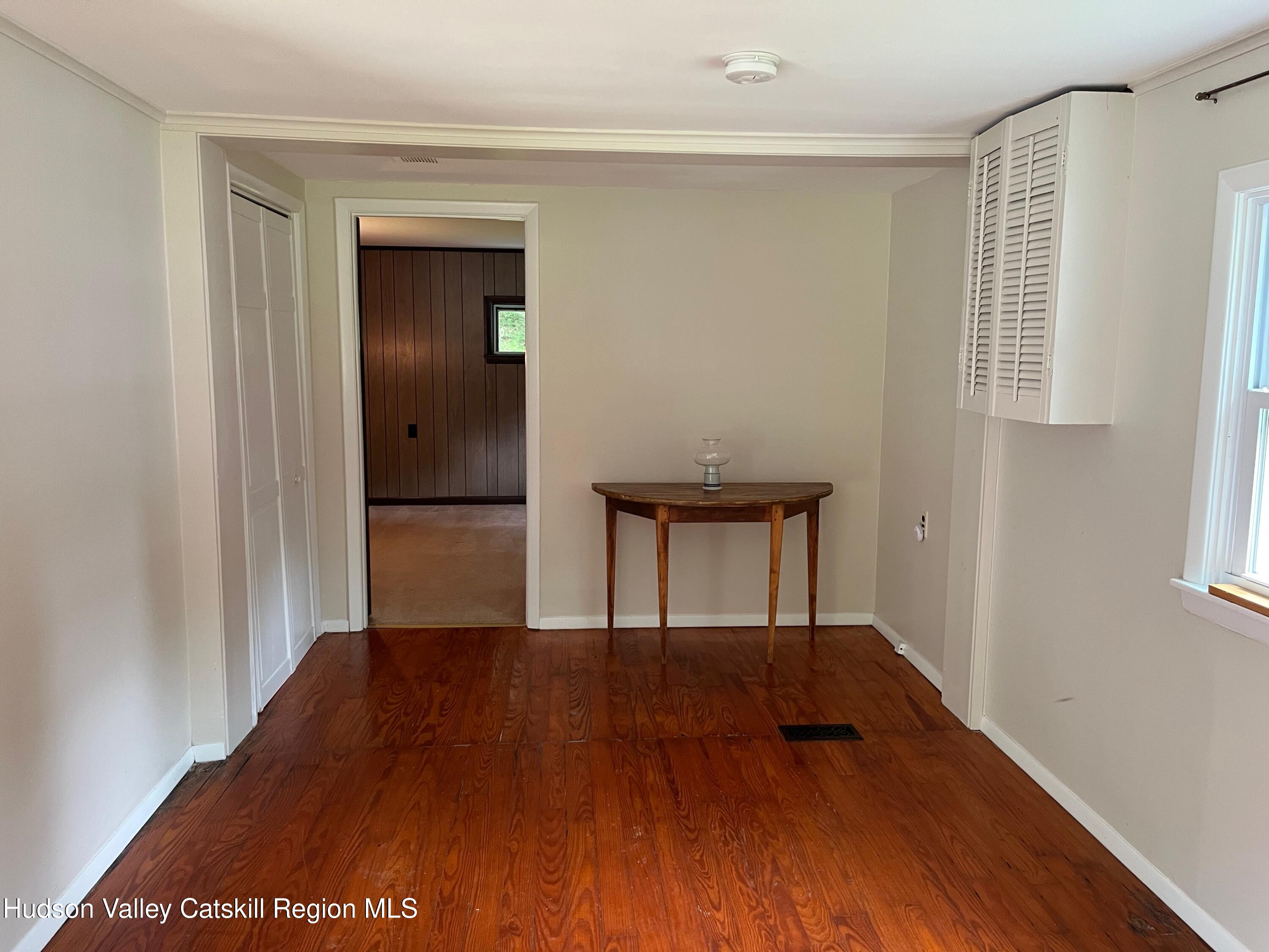601 Fischer Road Kinderhook, NY 12106 - Photo 5 of 13 a view of a hallway with wooden floor and a bathroom