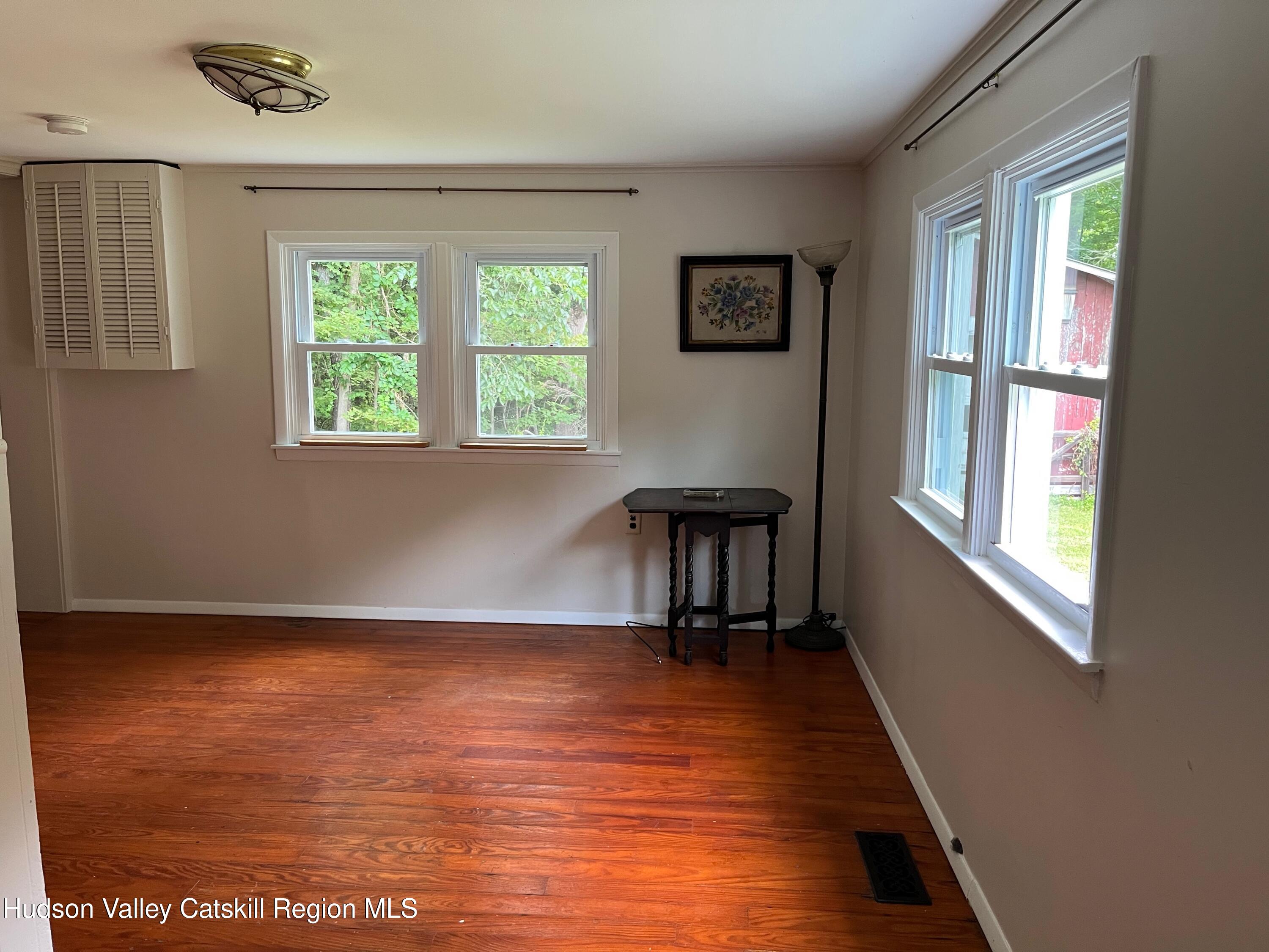 601 Fischer Road Kinderhook, NY 12106 - Photo 6 of 13 a view of an empty room with a window and wooden floor