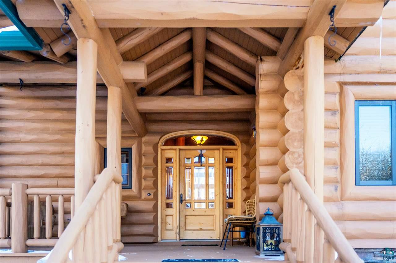 5960 North Pike Lake Road Duluth, MN 55811 - Photo 2 of 49 Walk past a peaceful fountain and up to a welcoming front porch to this stunning door!