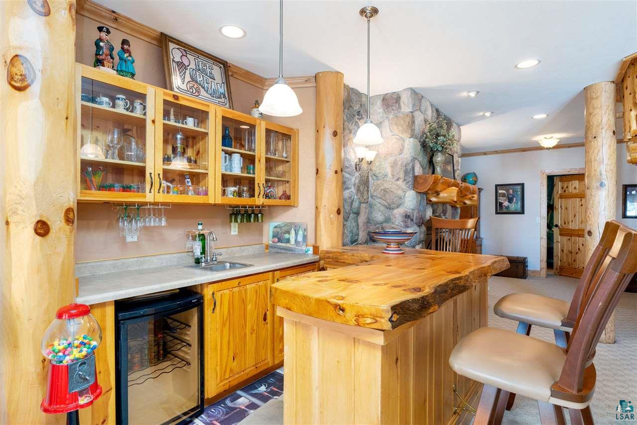 5960 North Pike Lake Road Duluth, MN 55811 - Photo 23 of 49 Sitting in the Walk out Lower Level! This custom bar with Brass Foot Rails is perfect for Fun!
