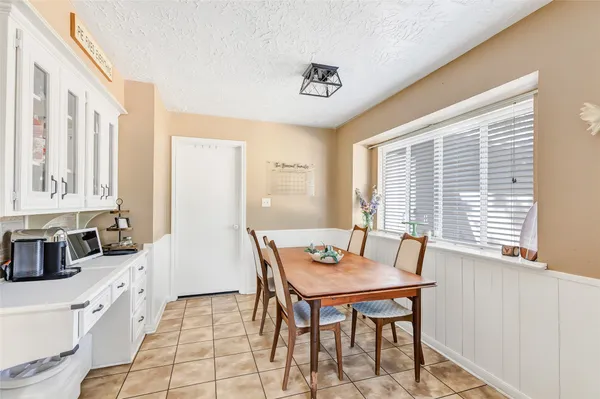 a view of a dining room with furniture and windows