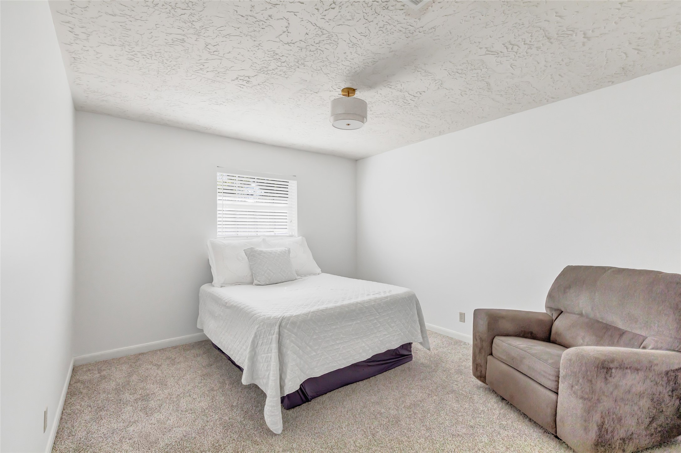 3 Baron's Place Conroe, TX 77304 - Photo 18 of 28 a bedroom with a bed couch and window