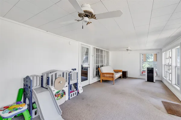 a bedroom with furniture and a book shelf