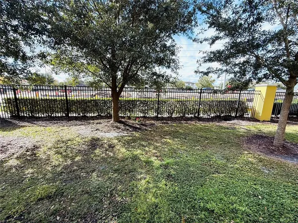 a view of a yard with wooden fence