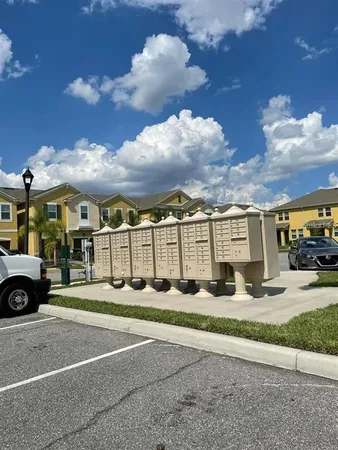 a view of a white house with a yard
