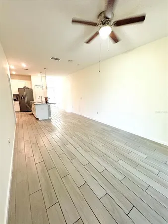 a view of a room with wooden floor