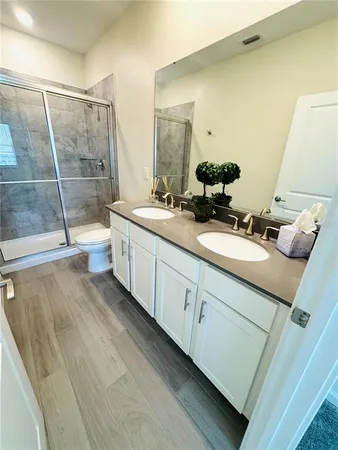 a bathroom with a double vanity sink and a mirror