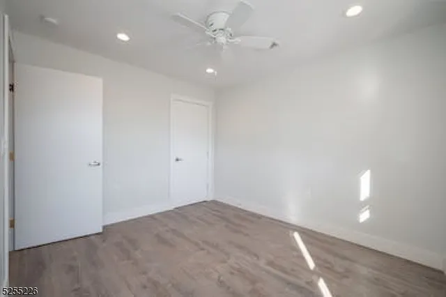 an empty room with fan and entrance