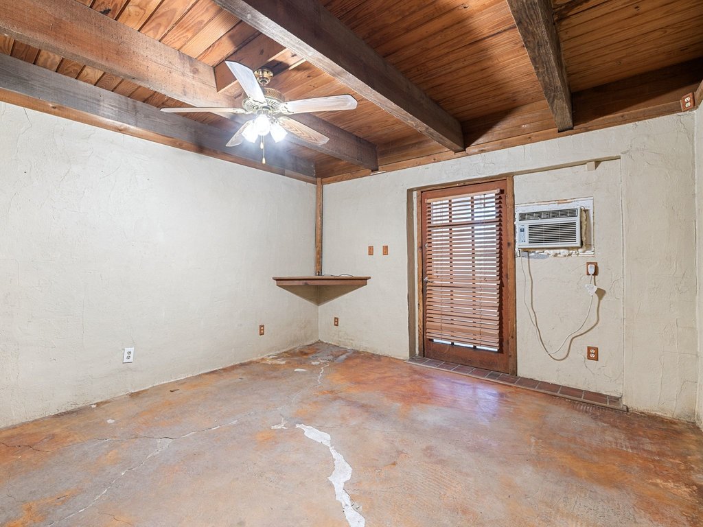 20416 Wilson Road Coupland, TX 78615 - Photo 14 of 39 Rich wood plank ceilings and sturdy exposed beams anchor this versatile lower-level space.