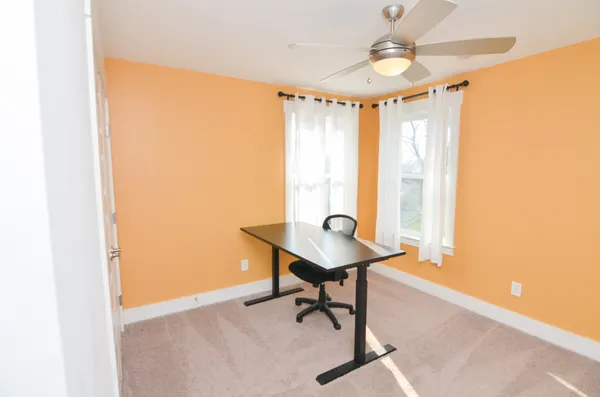 a view of a room with furniture and window