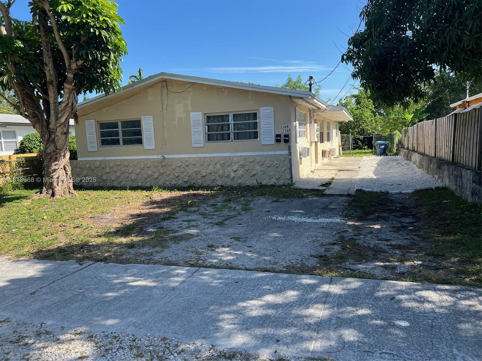 a view of a house with backyard and covered with trees