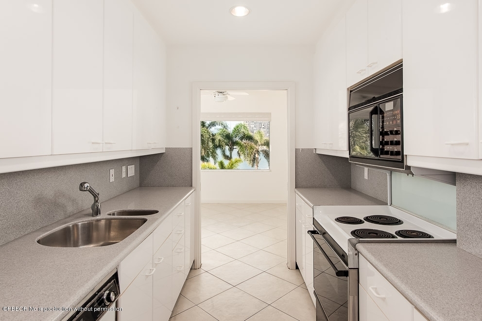 44 Cocoanut Row, Unit 214A Palm Beach, FL 33480 - Photo 6 of 13 a kitchen that has a sink and a stove