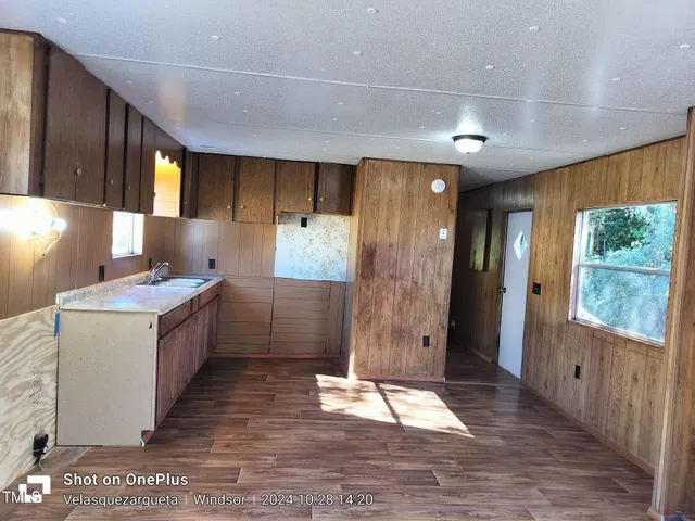a large kitchen with a large window and stainless steel appliances