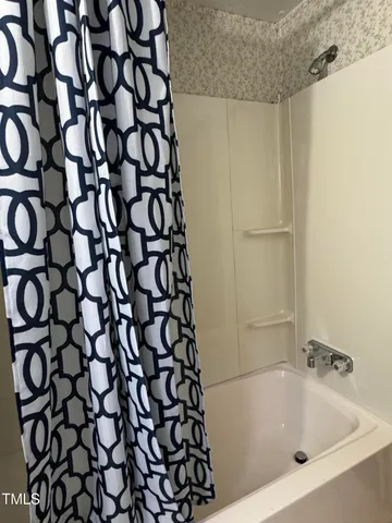 a bathroom with a bathtub and shower