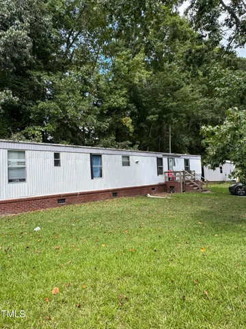 a view of a backyard with a garden and entertaining space