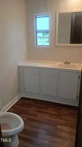 a view of a room with wooden floor and a window