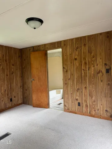 a view of an empty room and wooden walls
