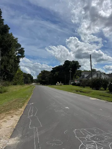 a view of a field of grass and trees