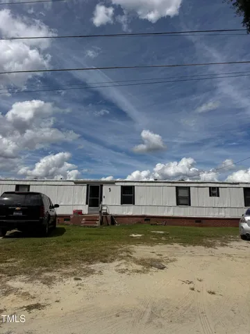 a view of a room with wooden floor and fence