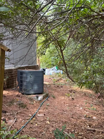 a view of a hallway with wooden floor and door
