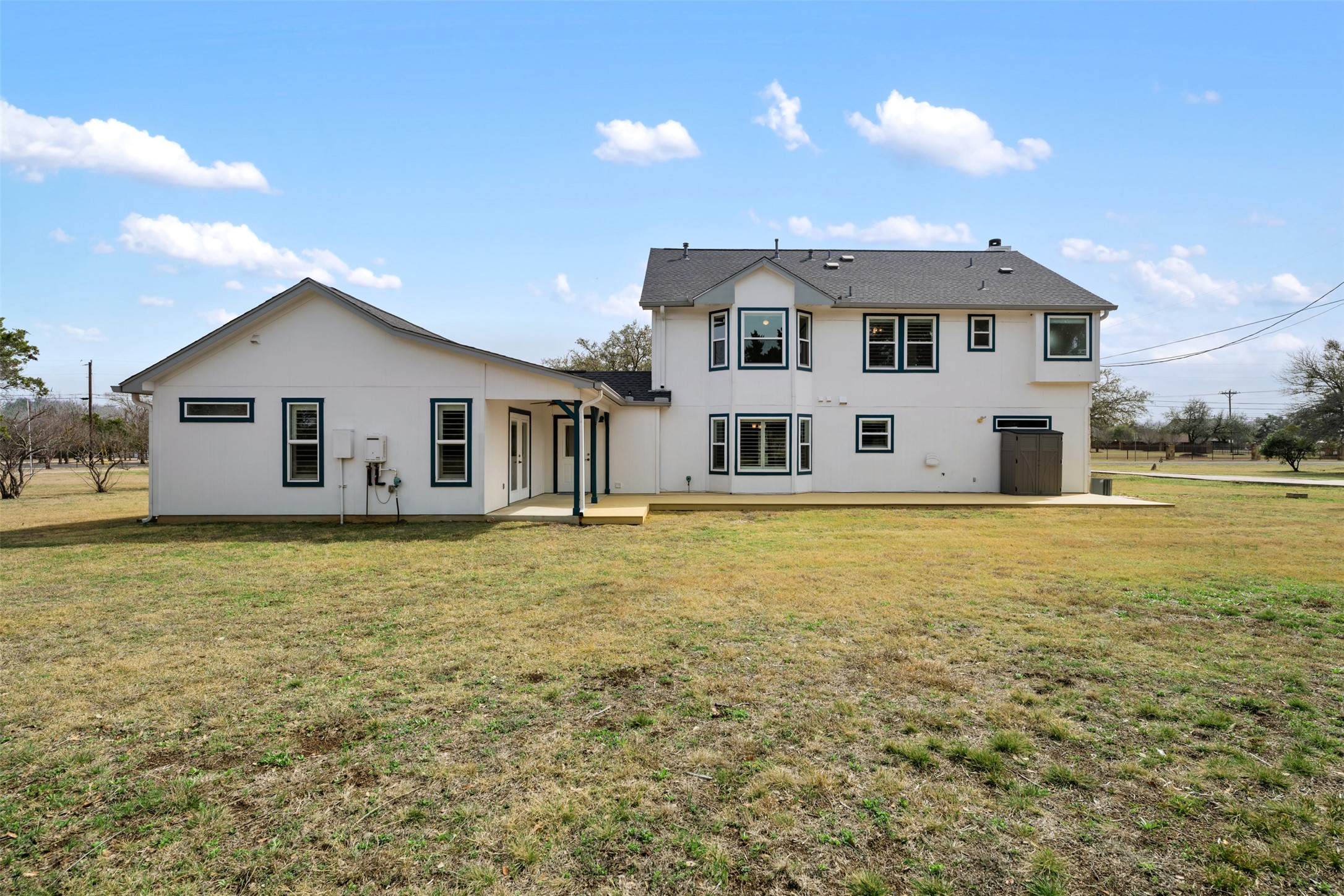 104 Sunset Road Georgetown, TX 78633 - Photo 36 of 40 Rear view of house with a patio, a yard, and stucco siding