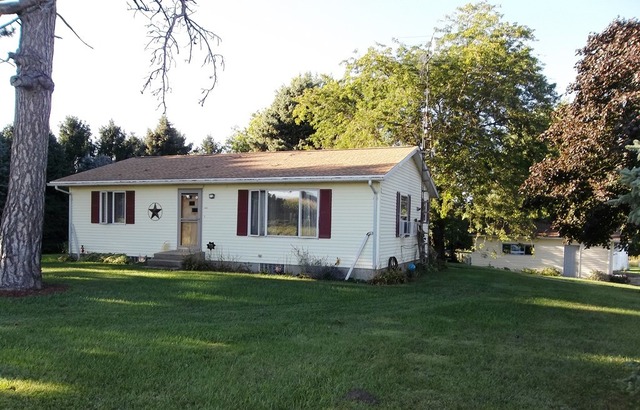 2240 Shaw Road West Brooklyn, IL 61378 - Photo 1 of 12 a view of a white house with a big yard and large trees
