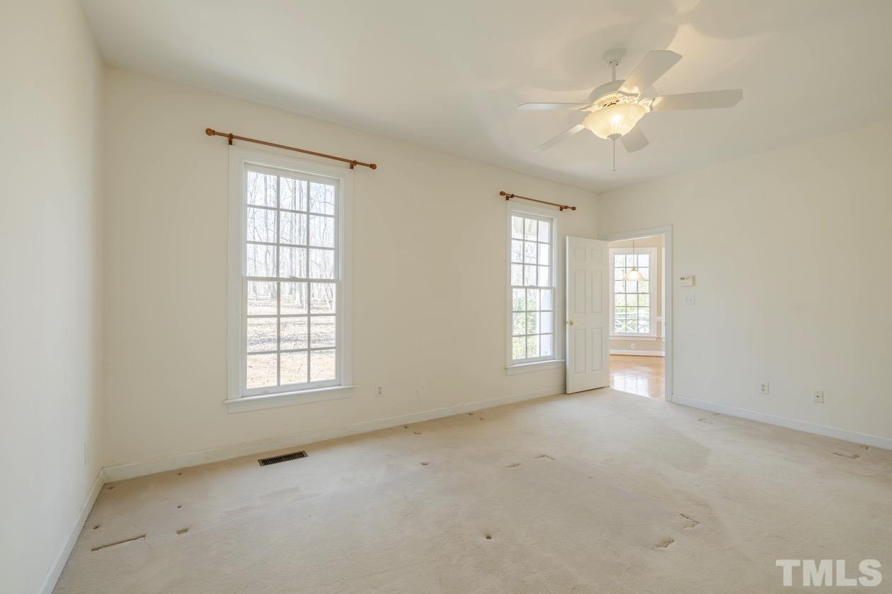 302 Shetland Road Rougemont, NC 27572 - Photo 43 of 47 an empty room with windows and chandelier fan