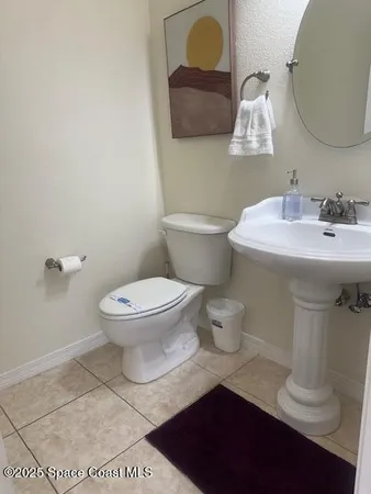 a bathroom with a sink toilet and mirror