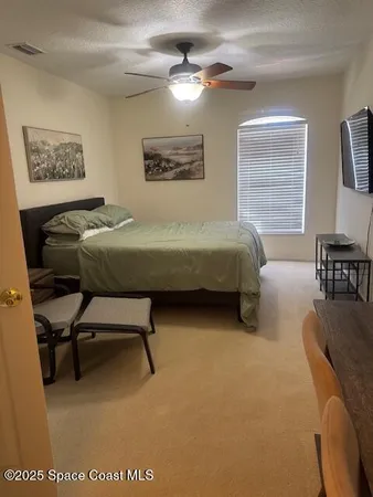 a bedroom with a bed and a desk