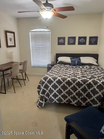 a bedroom with a bed and lamp with window